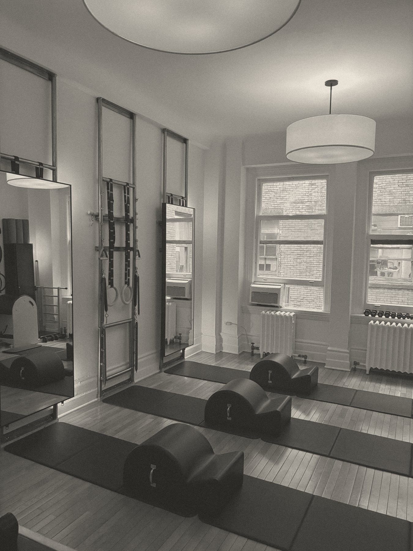 Spine correctors set out on mats beside the wall units in the evening light, Will Taylor Studio