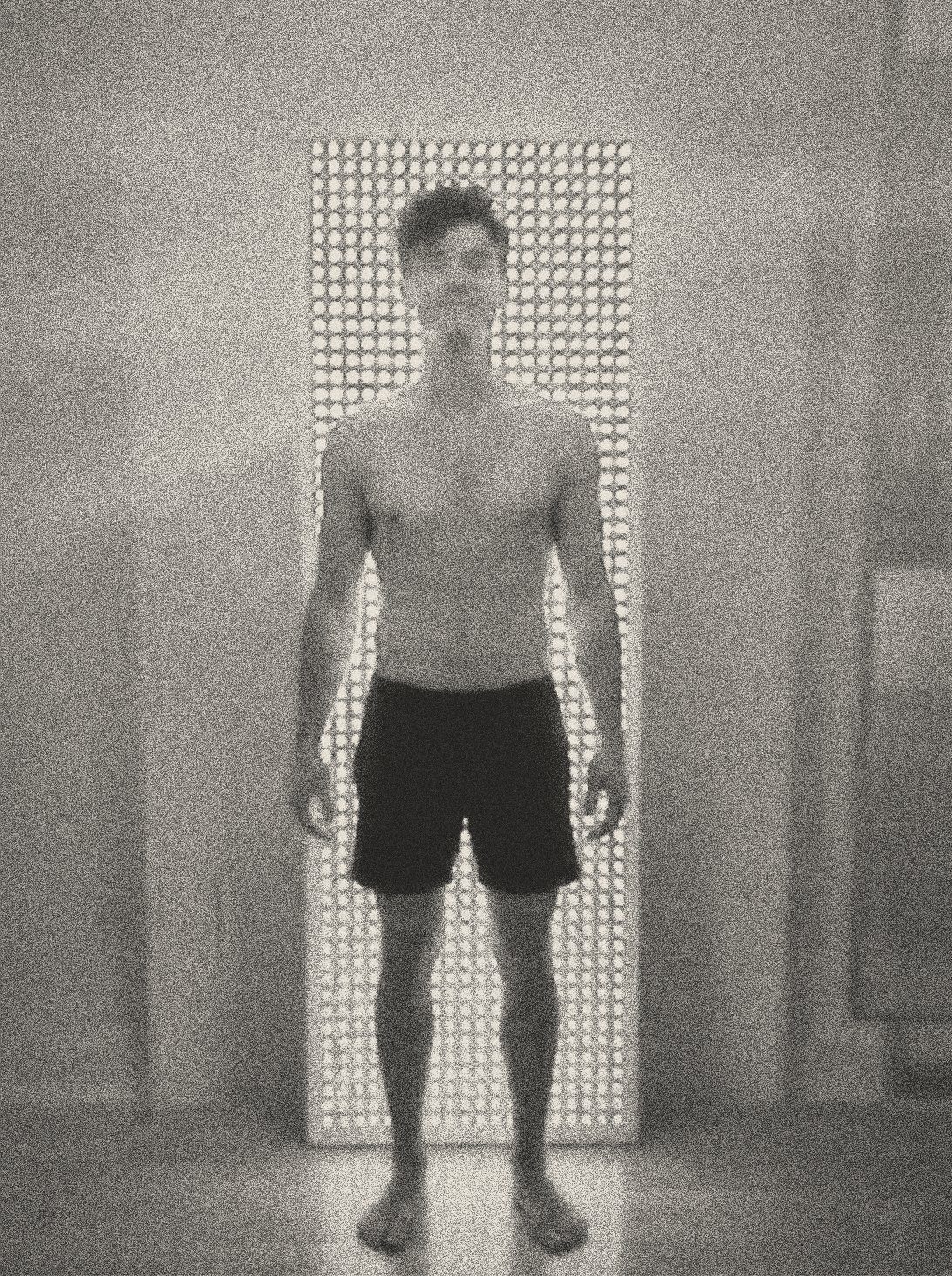 Client standing in front of the red light therapy panel at Will Taylor Studio